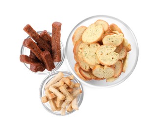 Photo of Different crispy rusks in bowls on white background, top view