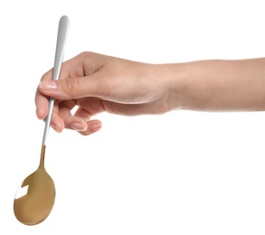 Photo of Woman holding clean tablespoon on white background, closeup