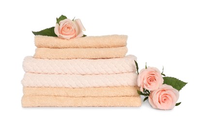 Stack of clean soft towels with flowers isolated on white