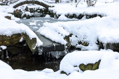 Photo of Fluffy snow and frozen pond in winter park