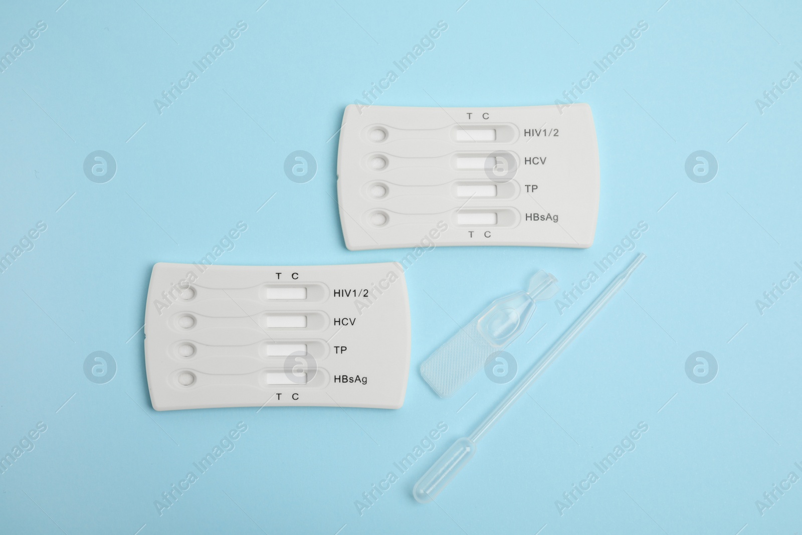 Photo of Disposable express test kit for hepatitis on light blue background, flat lay