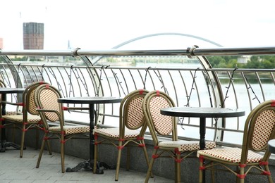 Photo of Stylish chairs and tables on cafe terrace