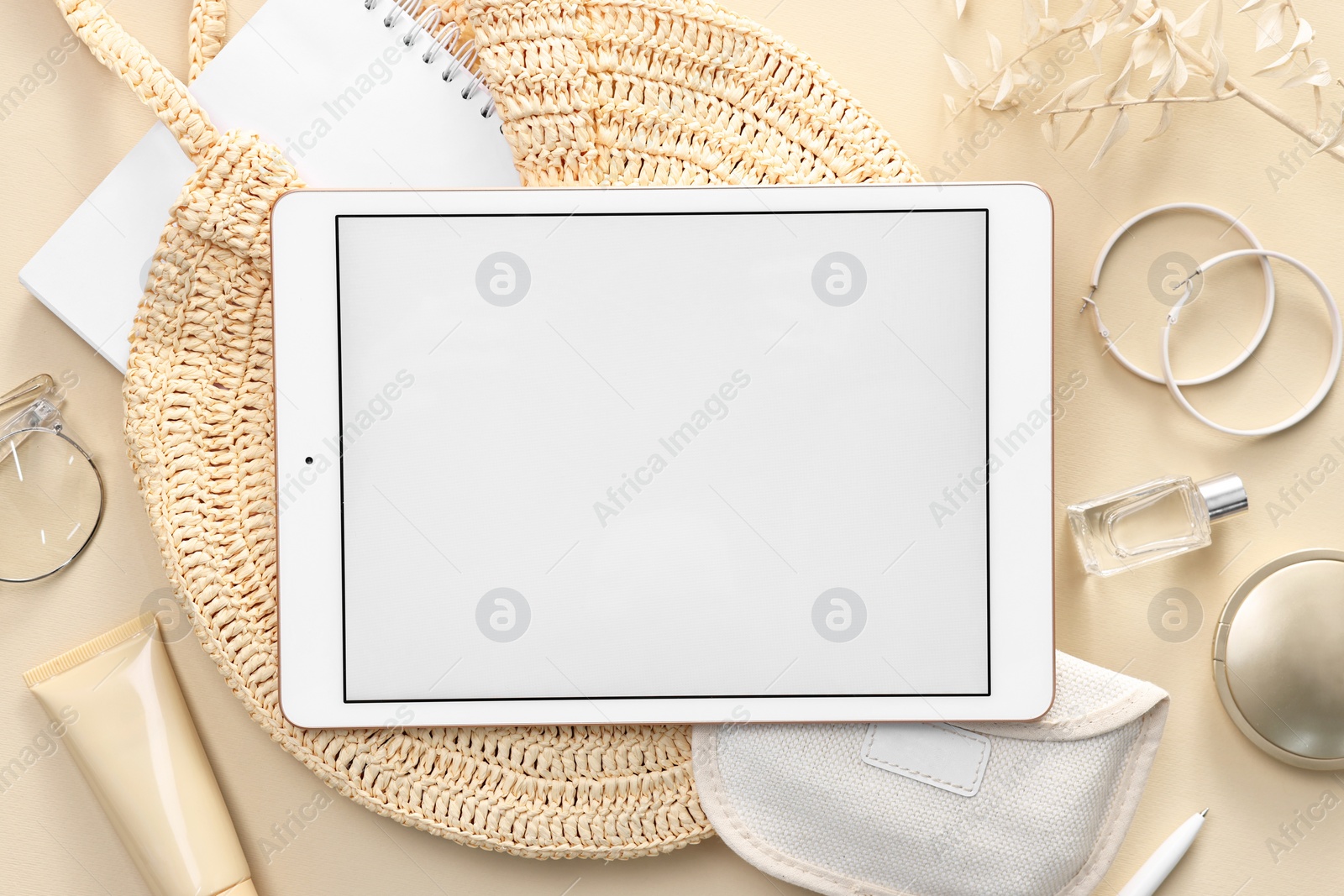 Photo of Flat lay composition with modern tablet on beige background. Space for text