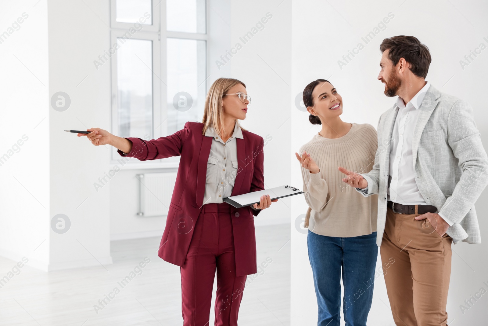 Photo of Real estate agent showing new apartment to couple