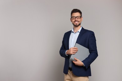 Photo of Happy teacher with glasses and stationery against beige background. Space for text