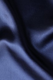 Crumpled dark blue silk fabric as background, top view