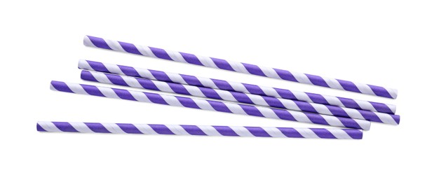 Photo of Striped paper cocktail straws on white background, top view