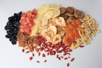 Photo of Different tasty dried fruits on white background, top view