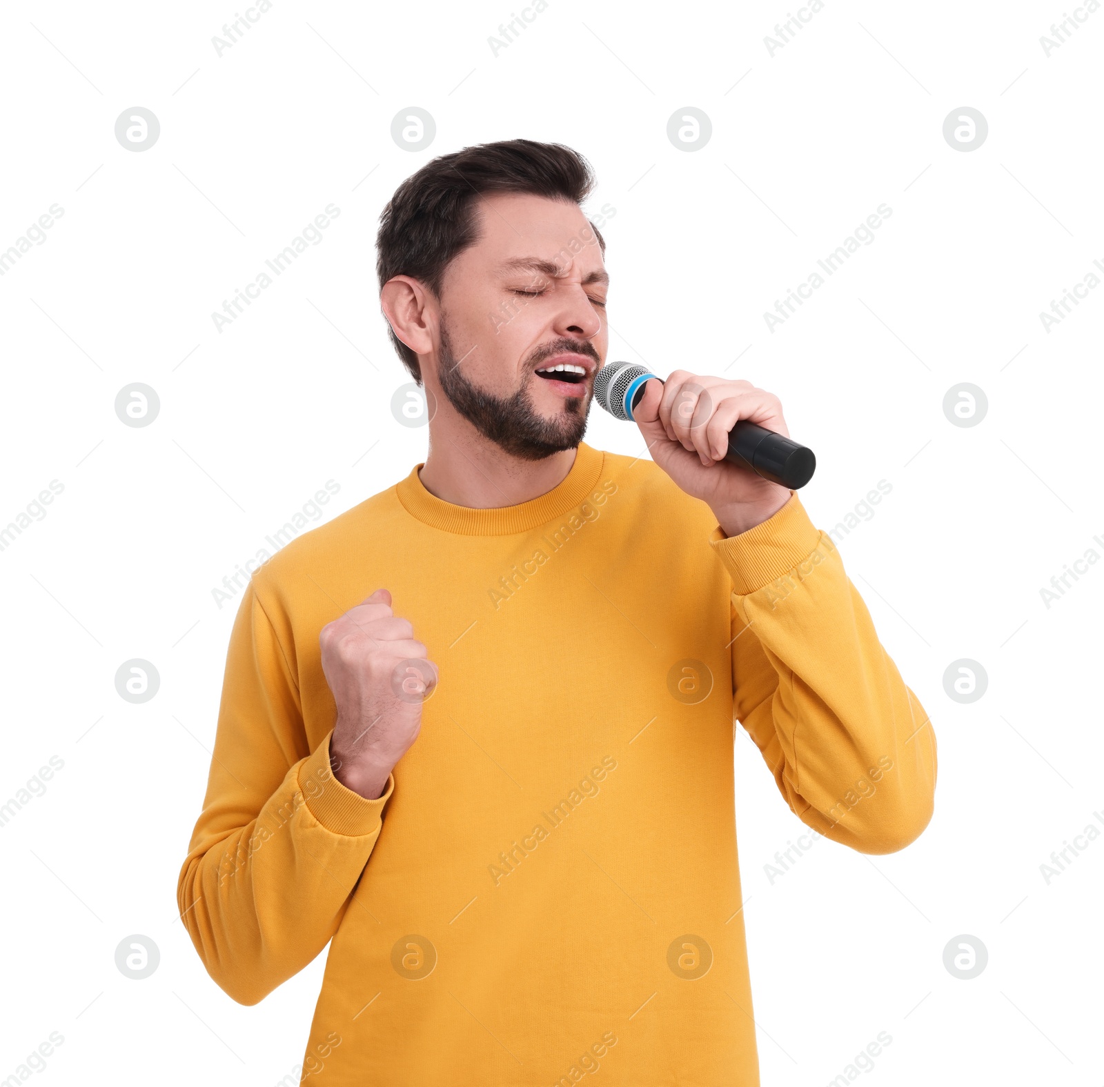 Photo of Handsome man with microphone singing on white background