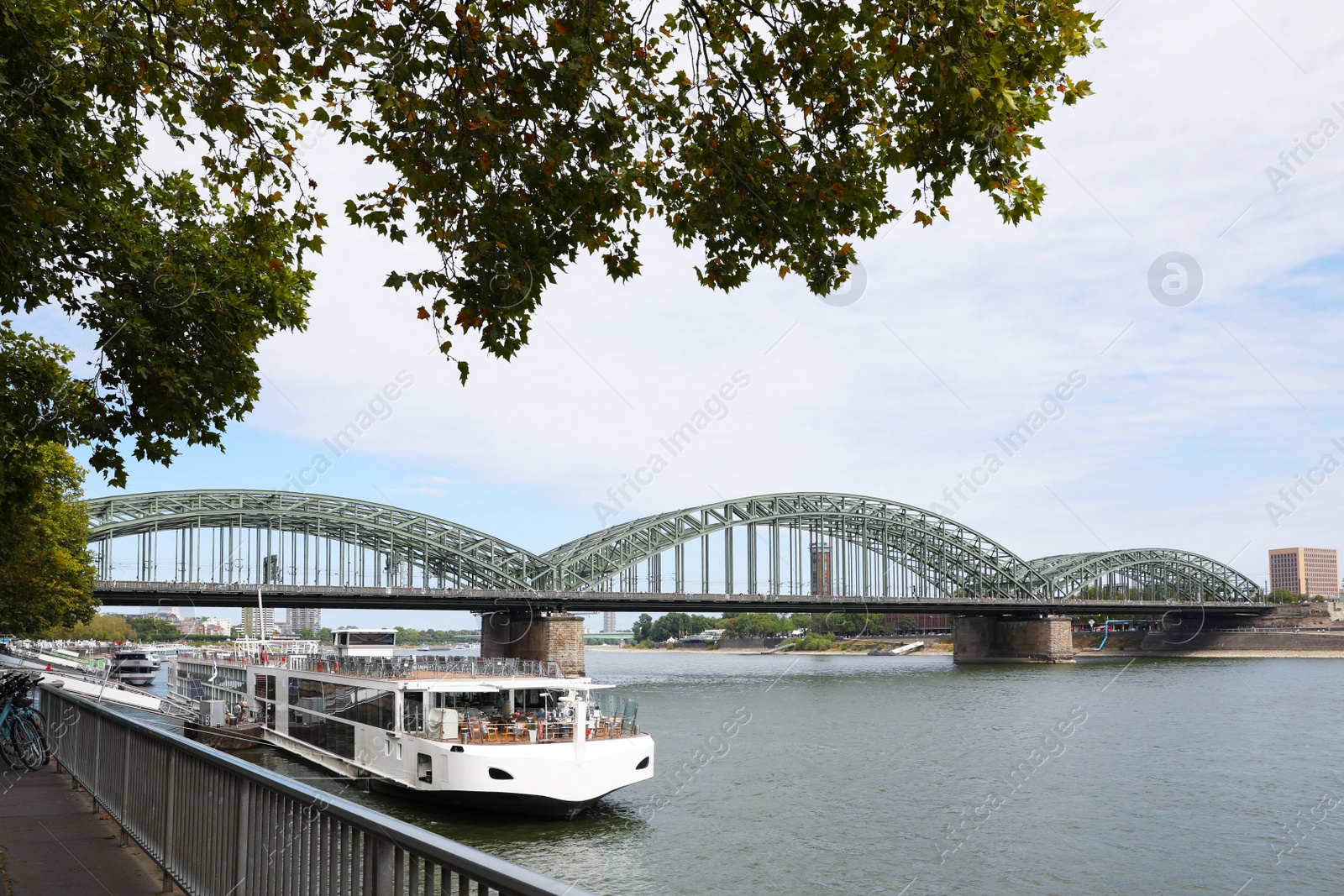 Photo of Picturesque view of a modern bridge over river and ferry boat