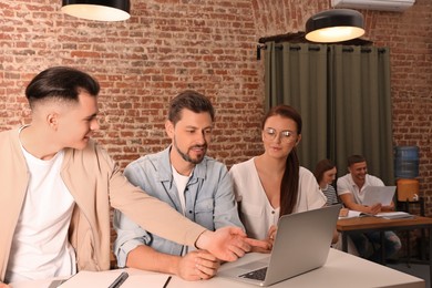 Team of employees working together in office