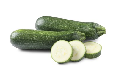 Photo of Whole and cut green ripe zucchinis isolated on white