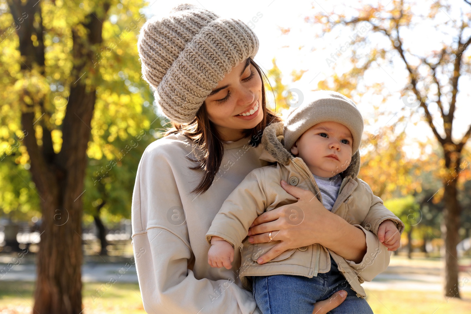 Photo of Happy mother with her baby son in park on autumn day