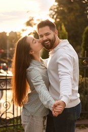 Lovely couple dancing together outdoors at sunset