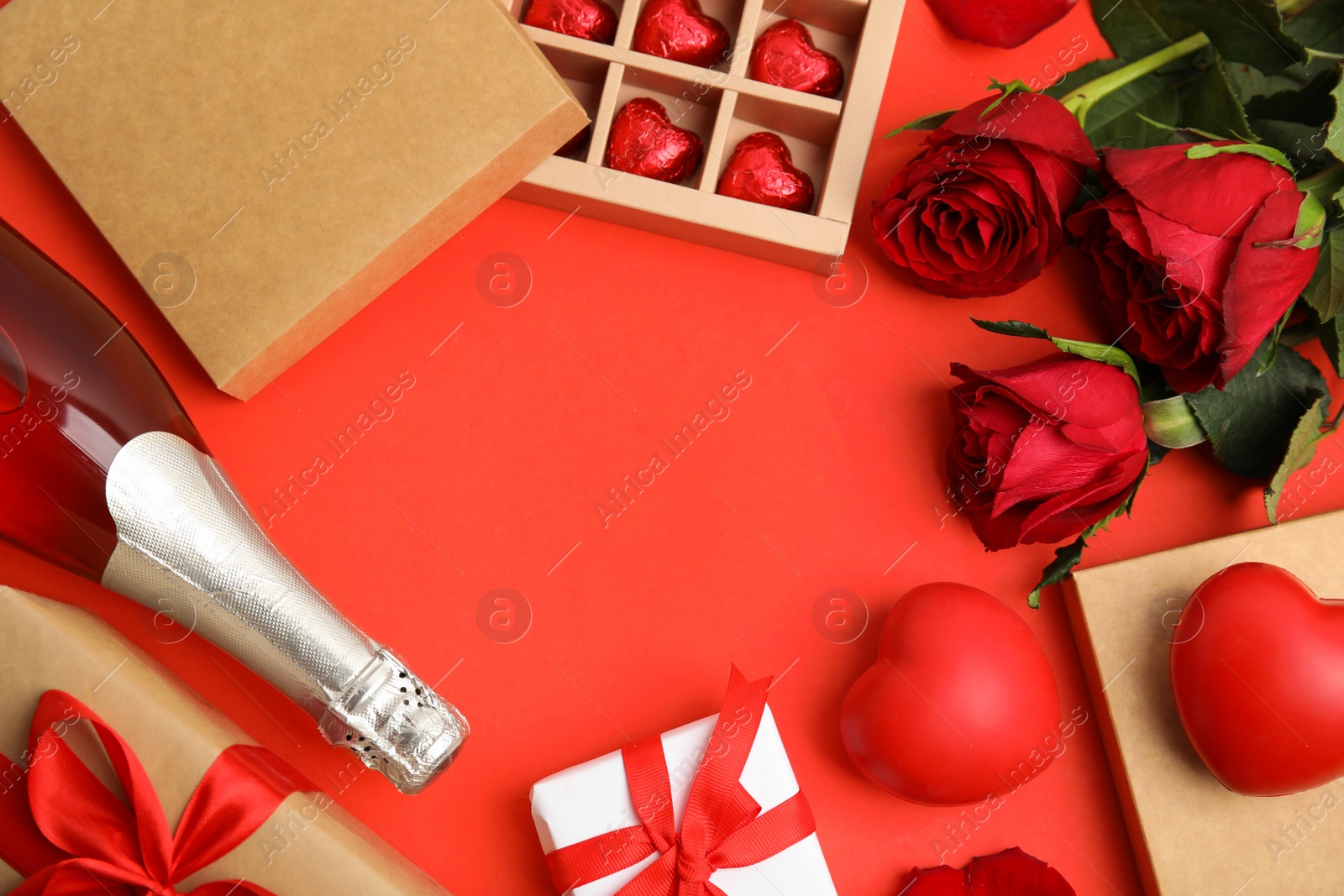 Photo of Flat lay composition with heart shaped chocolate candies on red background, space for text. Valentine's day celebration