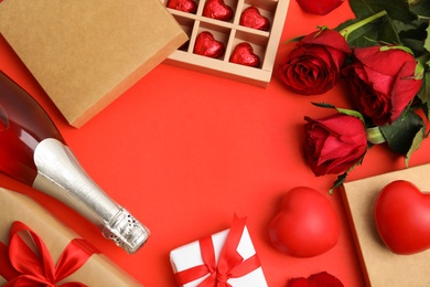 Photo of Flat lay composition with heart shaped chocolate candies on red background, space for text. Valentine's day celebration