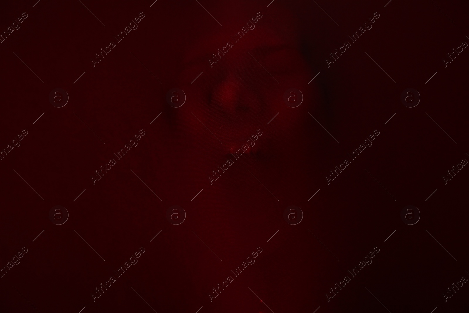 Photo of Silhouette of creepy ghost with skull behind brown cloth