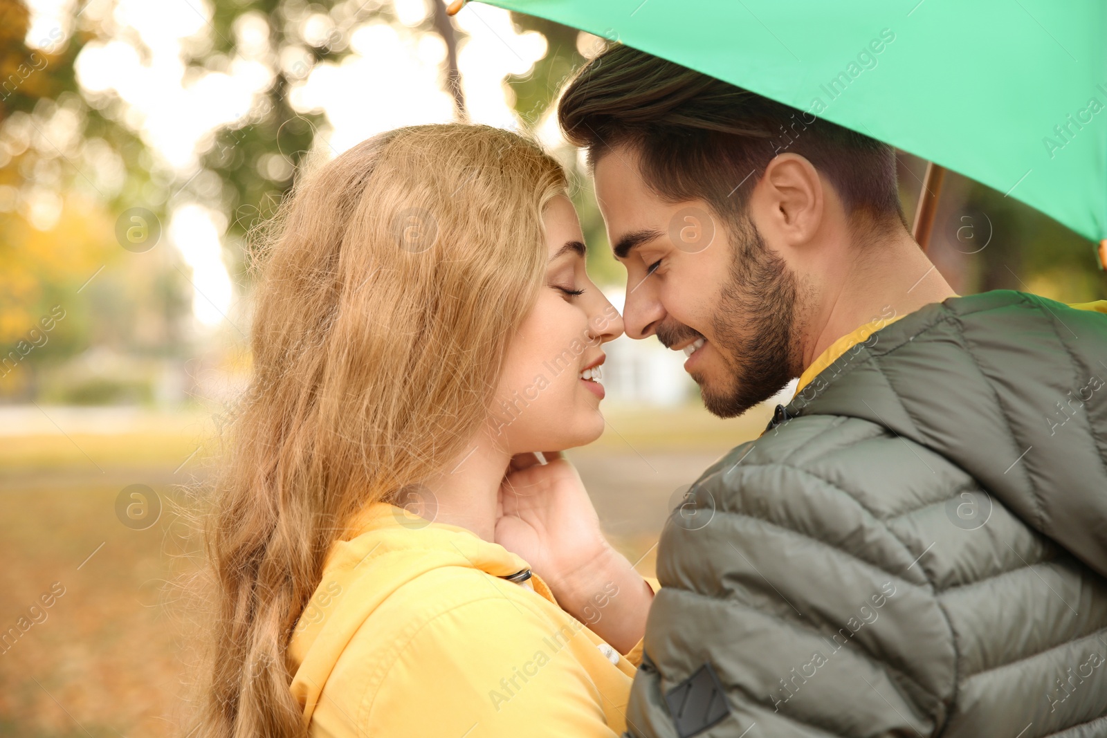 Photo of Happy couple with colorful umbrella in park