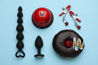 Flat lay composition with sex toys on light blue background