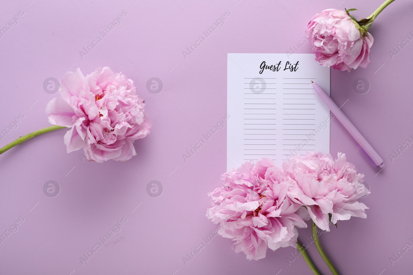 Photo of Guest list, pen and beautiful flowers on violet background, flat lay. Space for text