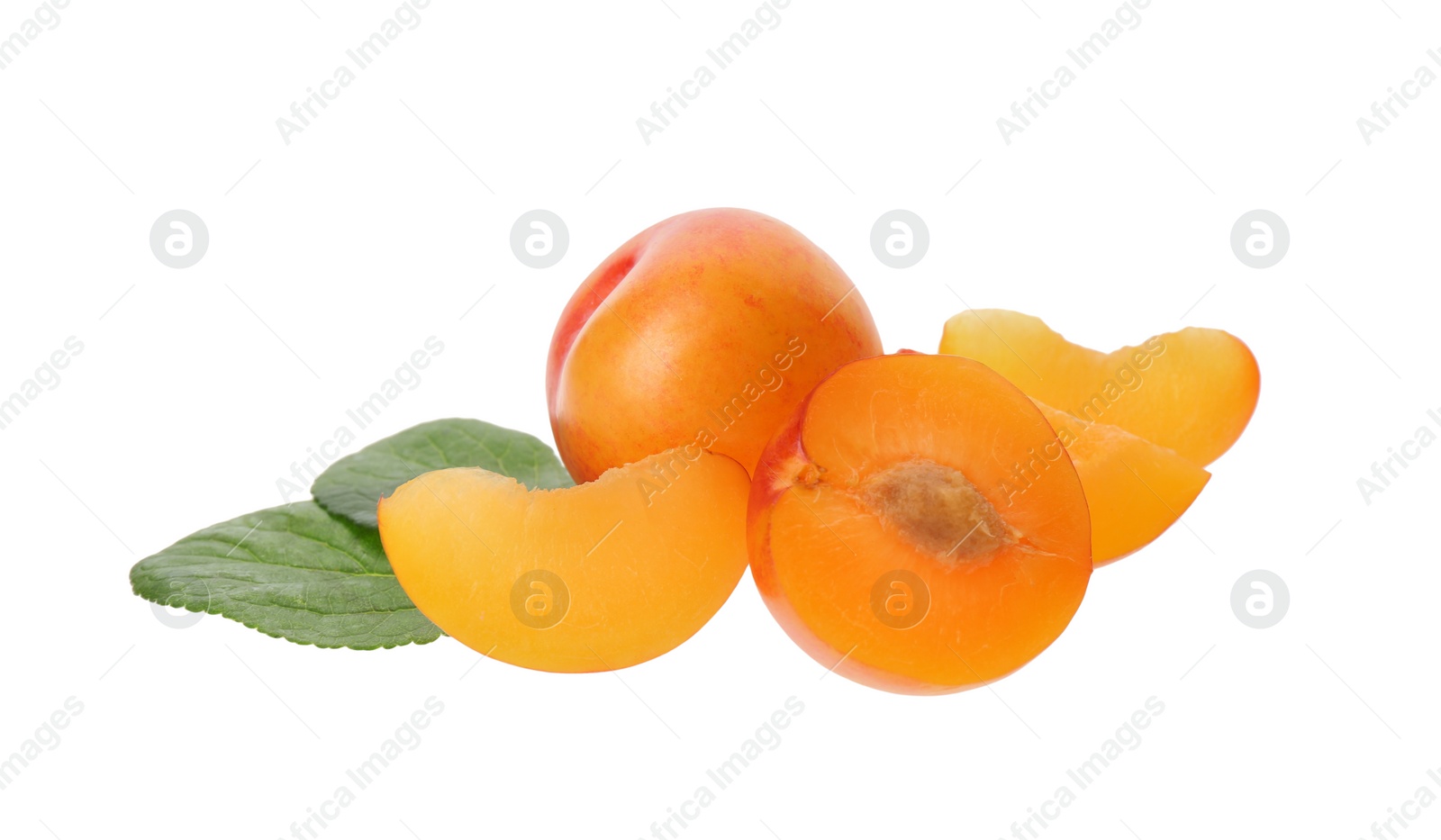 Photo of Whole and cut ripe plums with green leaves isolated on white