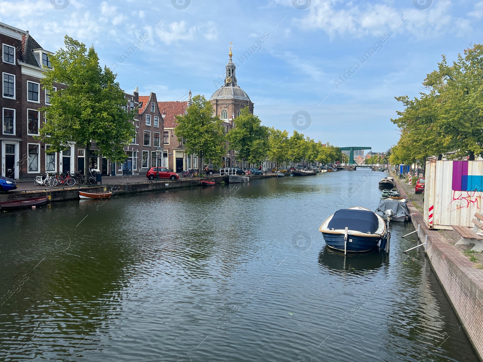 Photo of Leiden, Netherlands - August 28, 2022; Beautiful view of buildings near canal and boat on sunny day