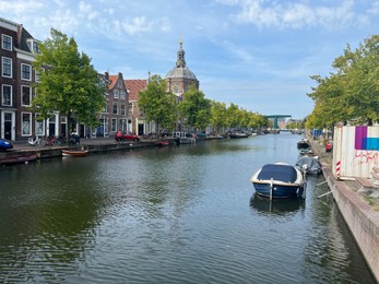 Photo of Leiden, Netherlands - August 28, 2022; Beautiful view of buildings near canal and boat on sunny day