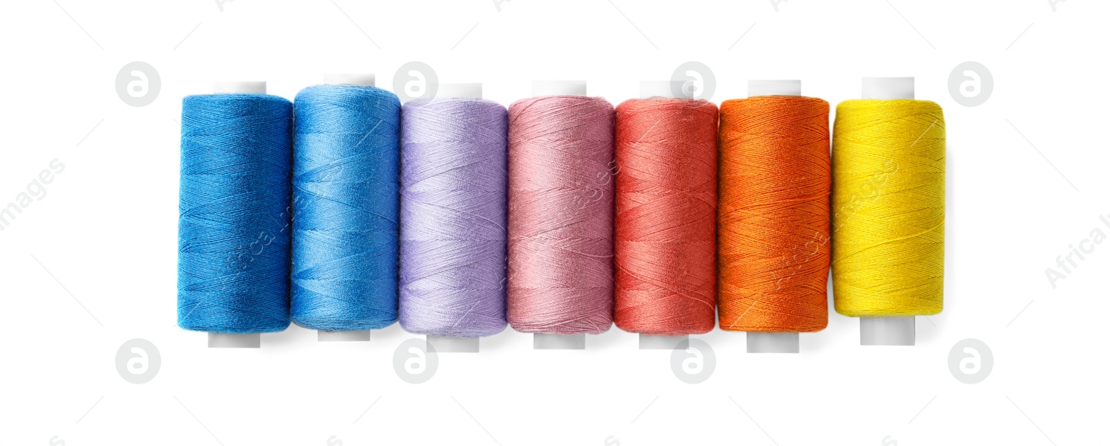 Photo of Set of different colorful sewing threads on white background, top view