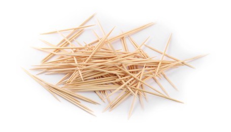 Heap of wooden toothpicks on white background