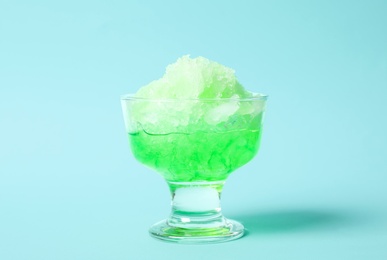 Photo of Shaving ice in glass dessert bowl on light blue background