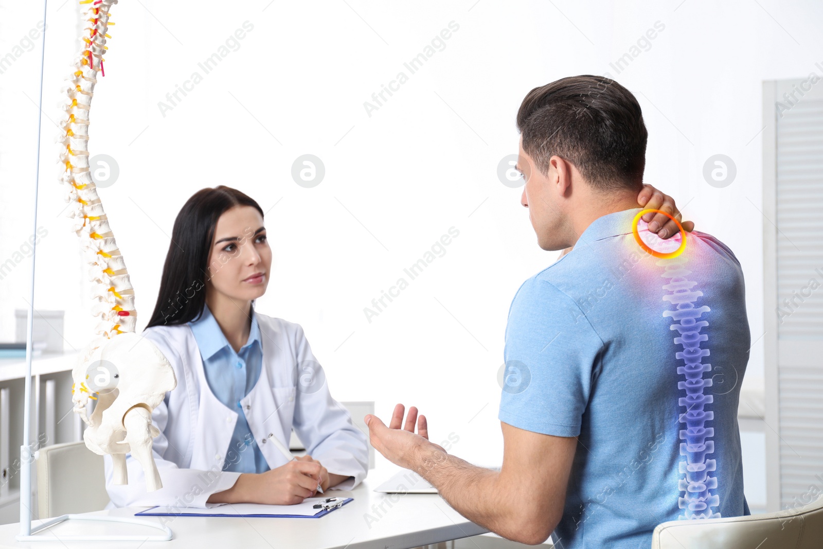 Image of Professional orthopedist examining man in medical office. Spinal pain