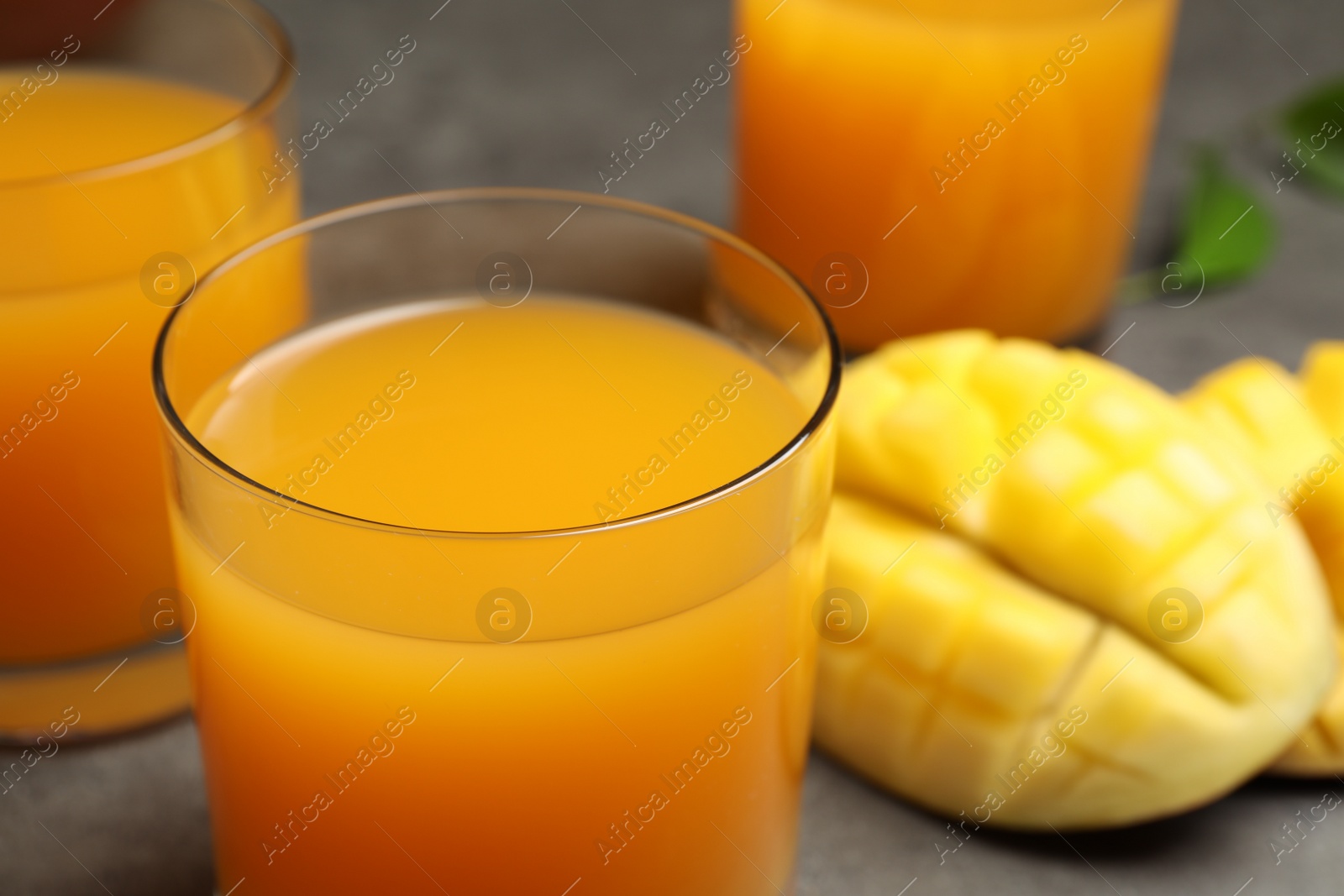 Photo of Fresh delicious mango drink on table, closeup