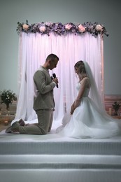 Photo of Groom saying marriage vow at wedding ceremony