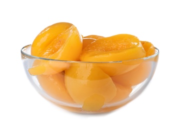 Bowl with halves of canned peaches on white background