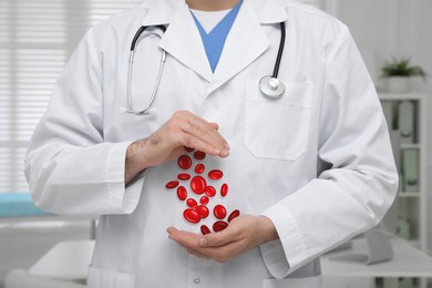 Image of Closeup view of doctor in clinic and illustration of red blood cells