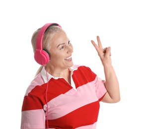 Photo of Mature woman enjoying music in headphones isolated on white