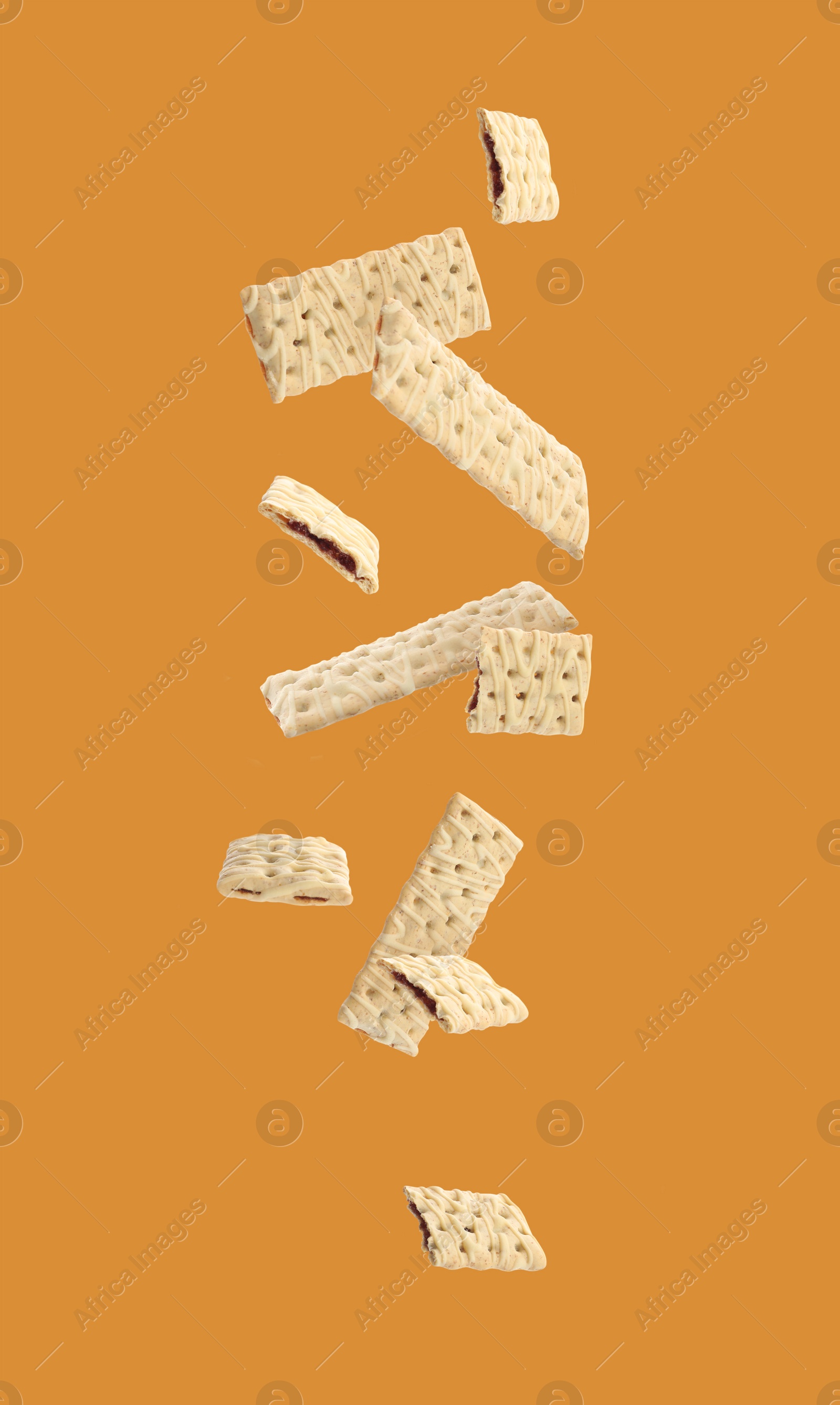 Image of Set of falling delicious cookies with filling on yellow background 