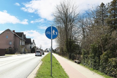 Photo of Traffic sign Compulsory Track For Pedestrians and Bicycles on city street