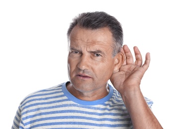 Mature man with hearing problem on white background