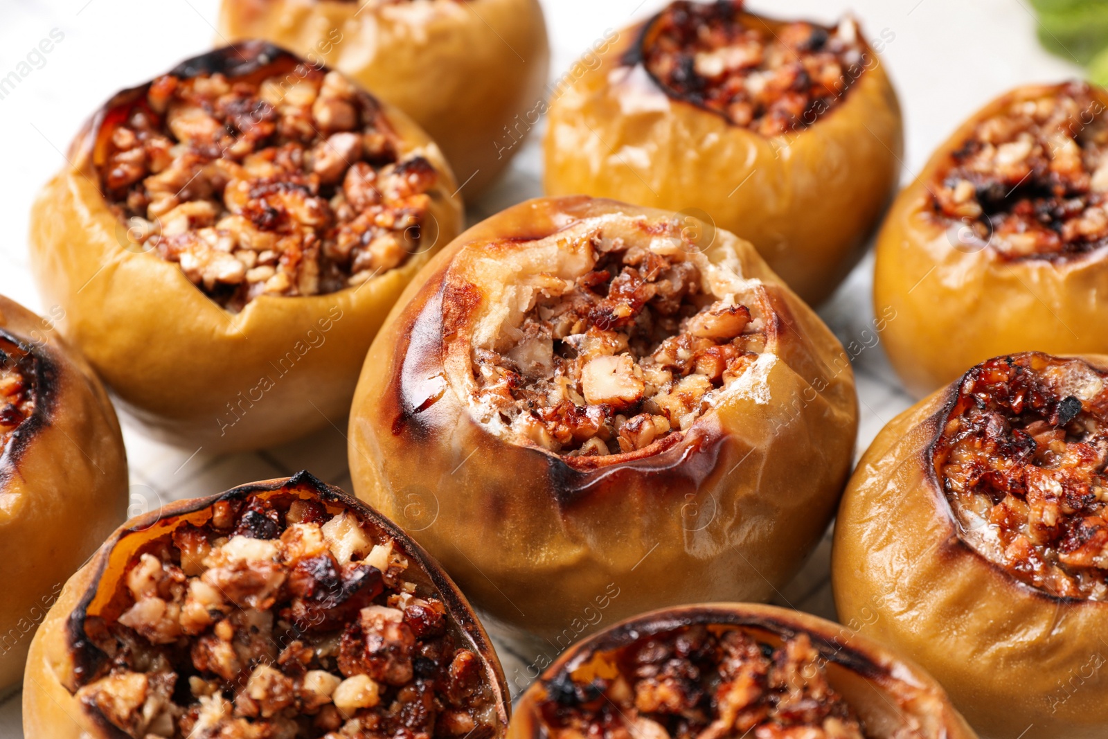 Photo of Delicious sweet baked stuffed apples, closeup view