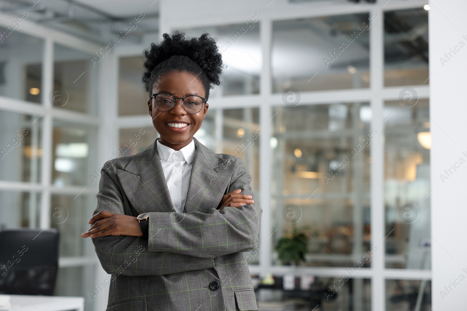 Photo of Happy woman with crossed arms in office, space for text. Lawyer, businesswoman, accountant or manager