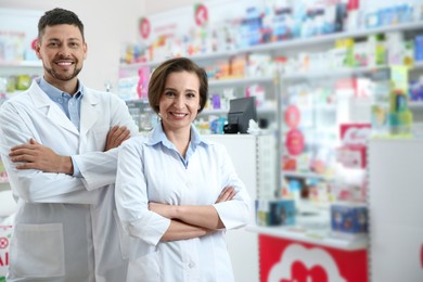 Photo of Portrait of professional pharmacists in modern drugstore