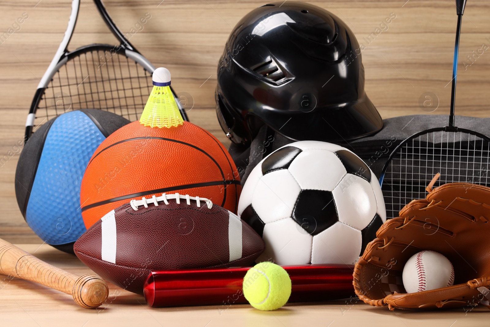 Photo of Many different sports equipment on wooden table