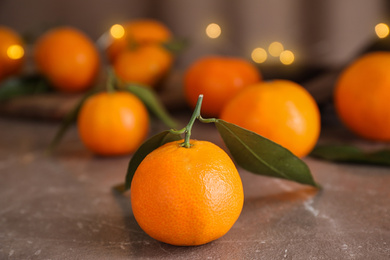 Tasty fresh ripe tangerines on brown table