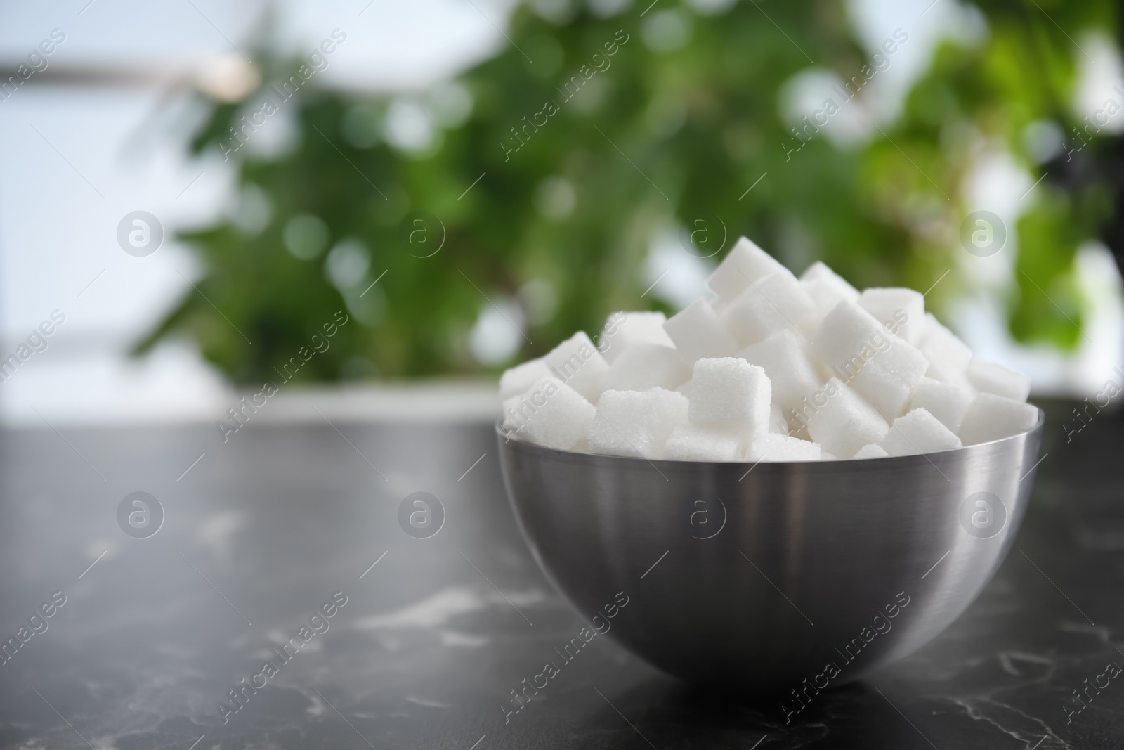 Photo of Bowl with refined sugar on table