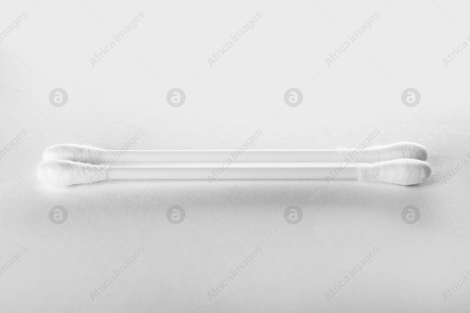 Photo of Clean cotton buds on white background. Hygienic accessory