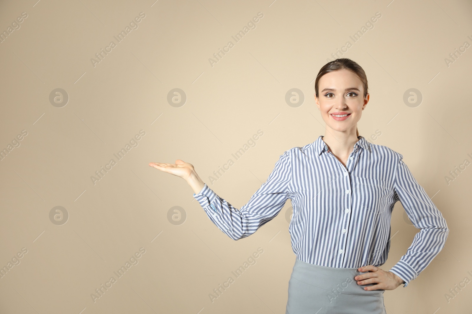 Photo of Portrait of young female teacher on beige background. Space for text