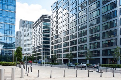 Bollards, cars and beautiful buildings in city