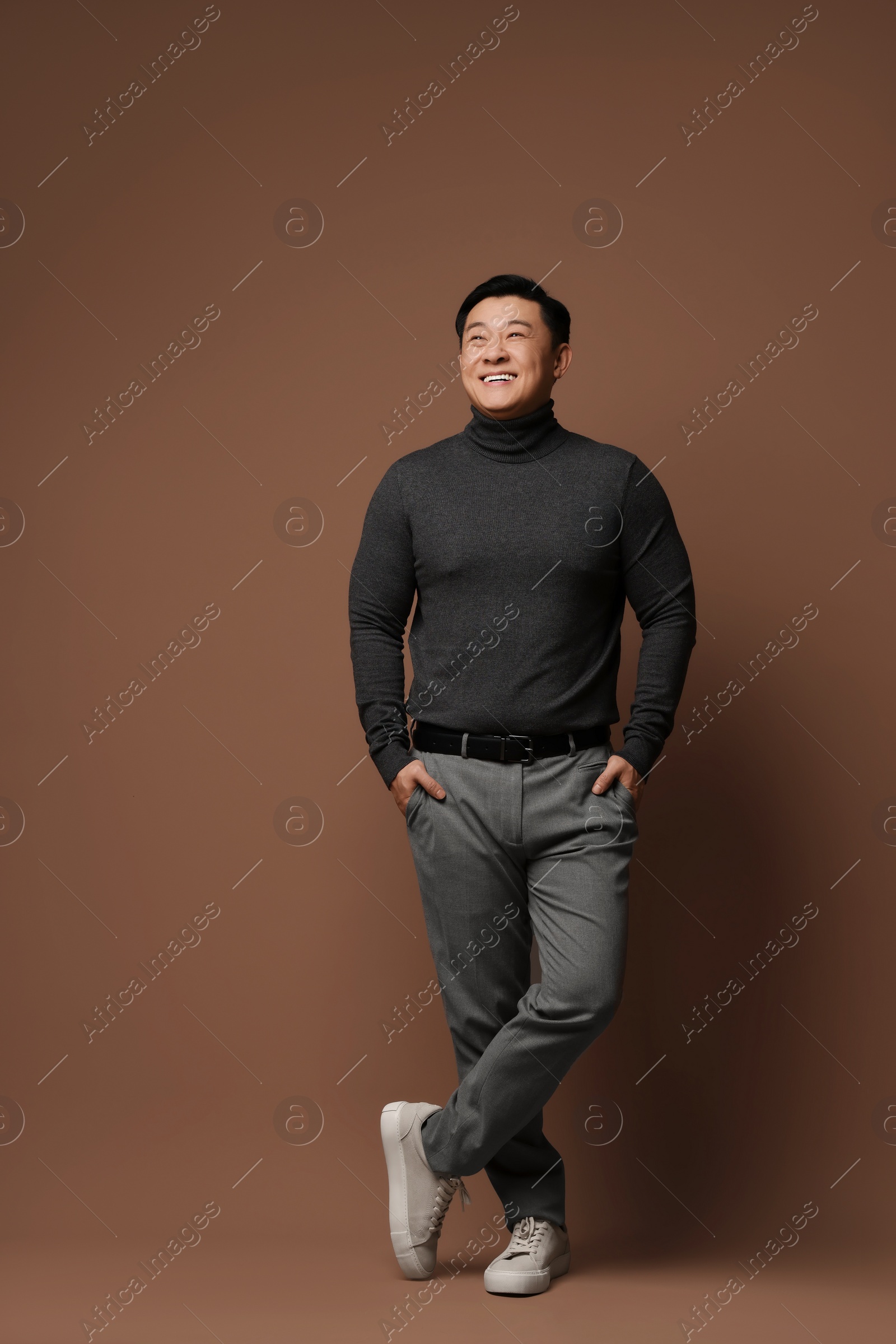 Photo of Full length portrait of happy man on brown background