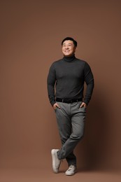 Photo of Full length portrait of happy man on brown background